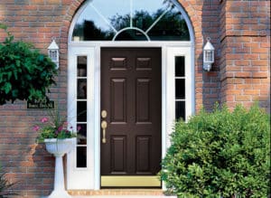 stately brick home, black front door with gold accents