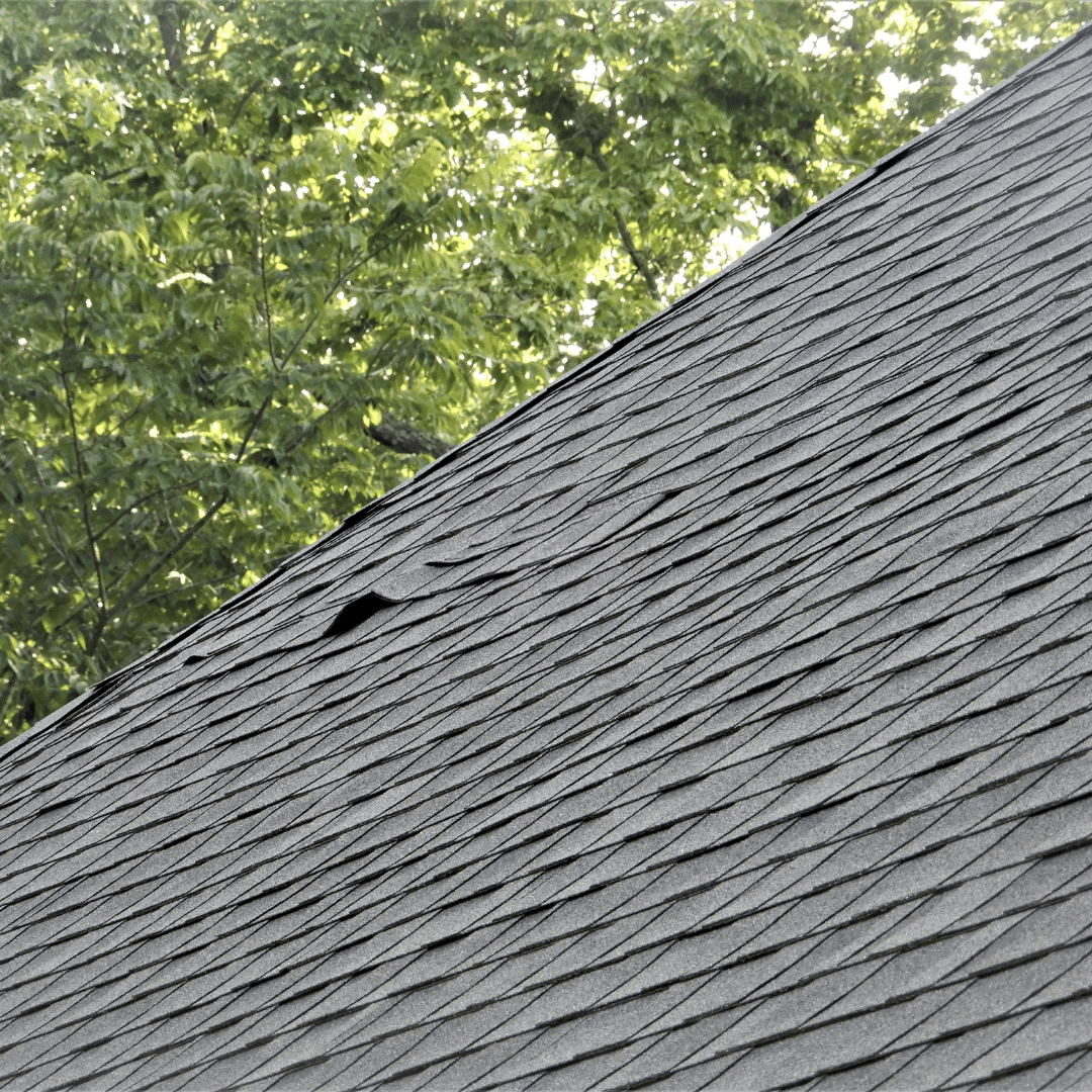 close up roof with damaged shingles